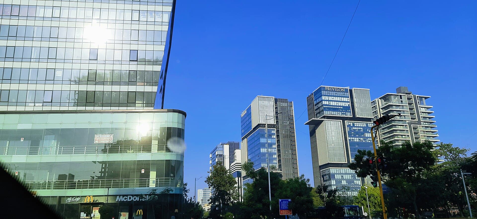 Glass office towers along SG Highway, Ahmedabad, under a clear blue sky
